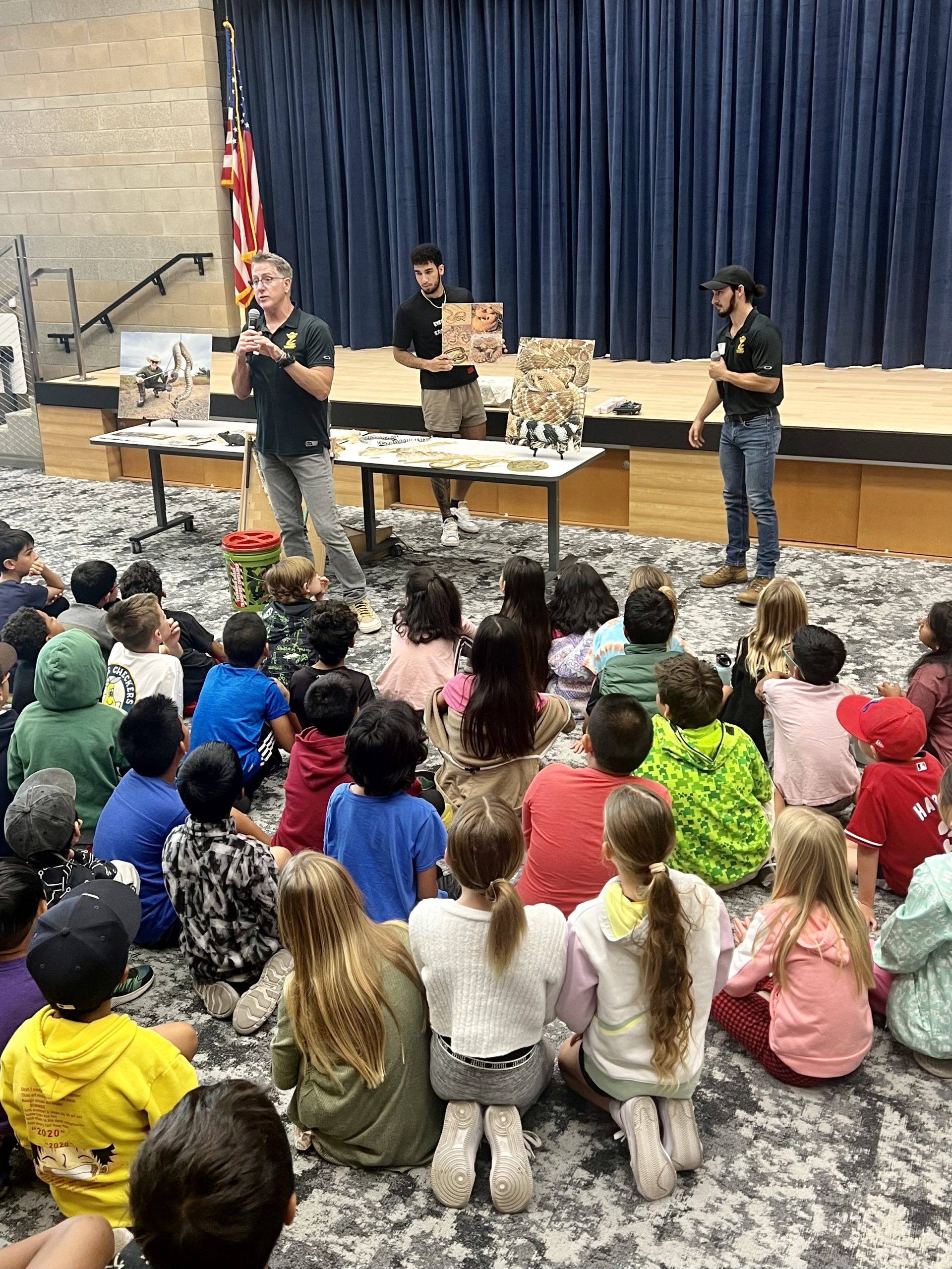 Wranglers Bruce, Allen and Grayson give the students at Pacific Sky Elementary a lesson about snakes.